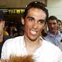Tour de France winner Contador smiles upon arriving at Madrid's Barajas airpor