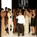 Models surround designer Jesus del Pozo during the Spring/Summer 2006-07 Pasarela Cibeles fashion show in Madrid