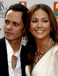 Actress Jennifer Lopez and husband Marc Anthony pose at the Los Angeles premiere of the film El Cantante