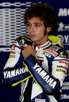 Italy's Valentino Rossi of MotoGP Yamaha adjusts his suit before starting the third the first free practice session at the Estoril track for the Portuguese Grand Prix